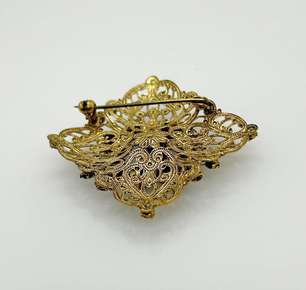 Intricate Vintage Gold Tone Brooch with Ruby Red Stones